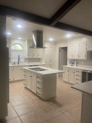 a kitchen with stainless steel appliances a sink stove and cabinets