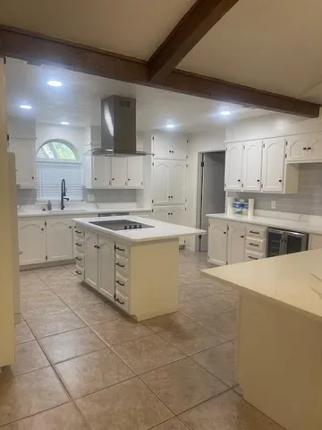 a kitchen with a stove a sink and a refrigerator