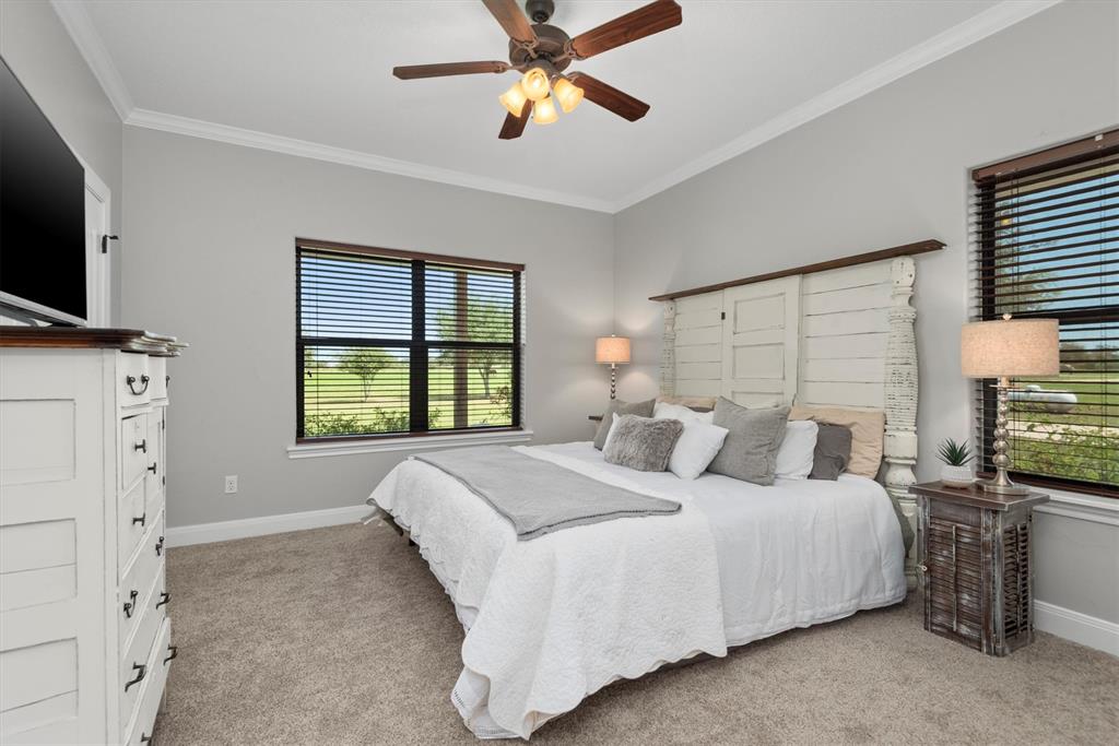 3759 Cr 126 Road Bedias, TX 77831 - Photo 15 of 38 a bedroom with a bed and a chandelier