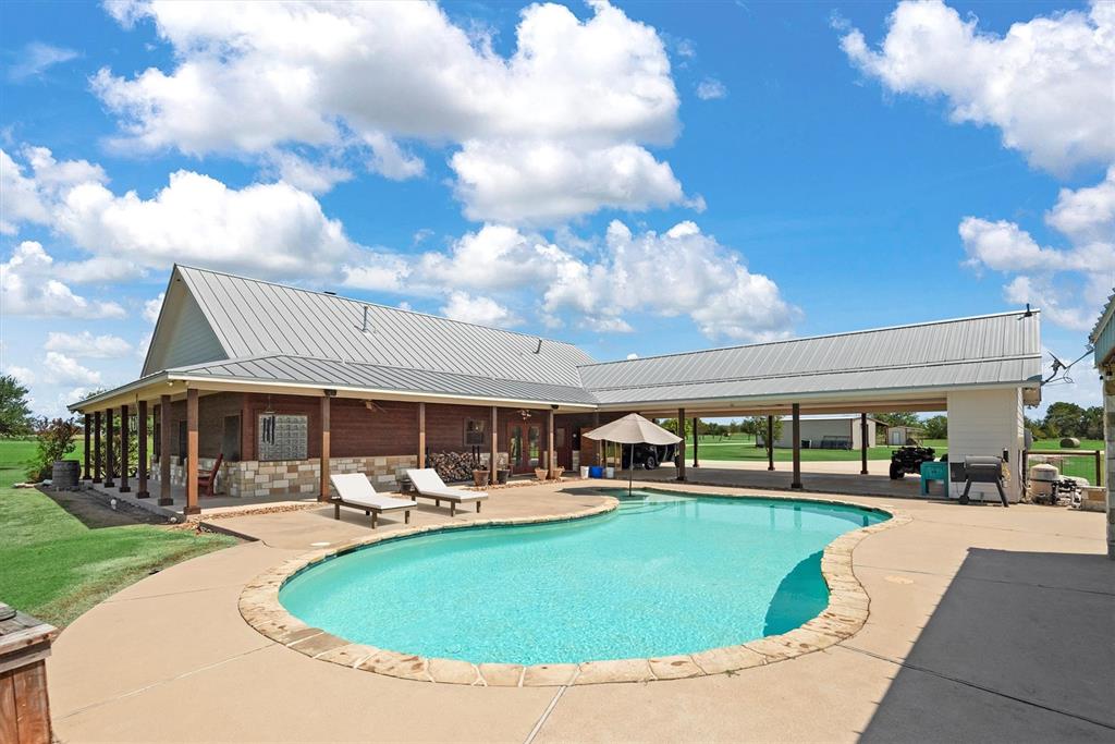 3759 Cr 126 Road Bedias, TX 77831 - Photo 19 of 38 a swimming pool with outdoor seating and yard
