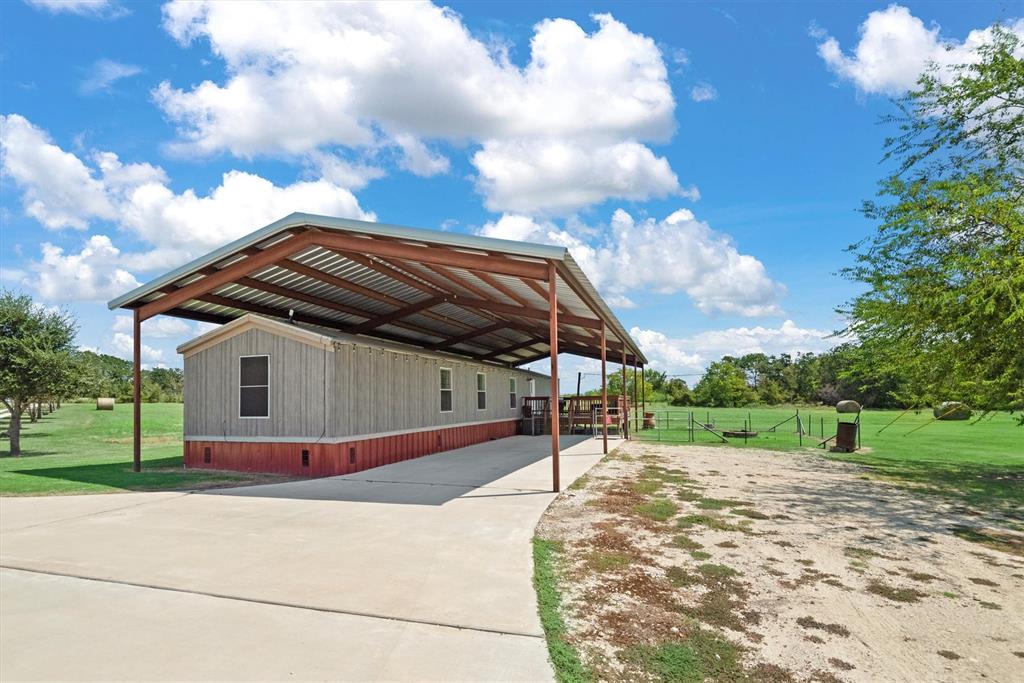 3759 Cr 126 Road Bedias, TX 77831 - Photo 24 of 38 a view of backyard of house and car parked