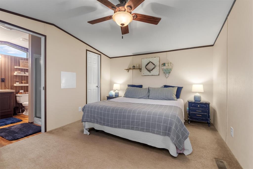 3759 Cr 126 Road Bedias, TX 77831 - Photo 29 of 38 a bedroom with a bed and a chandelier