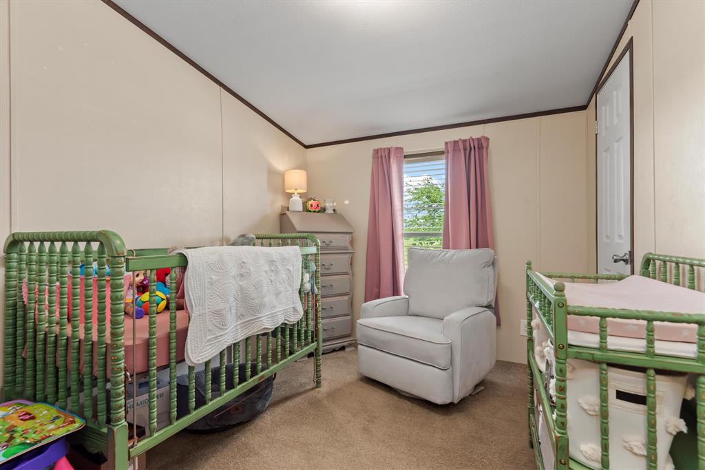 3759 Cr 126 Road Bedias, TX 77831 - Photo 31 of 38 a bedroom with a bed and a window