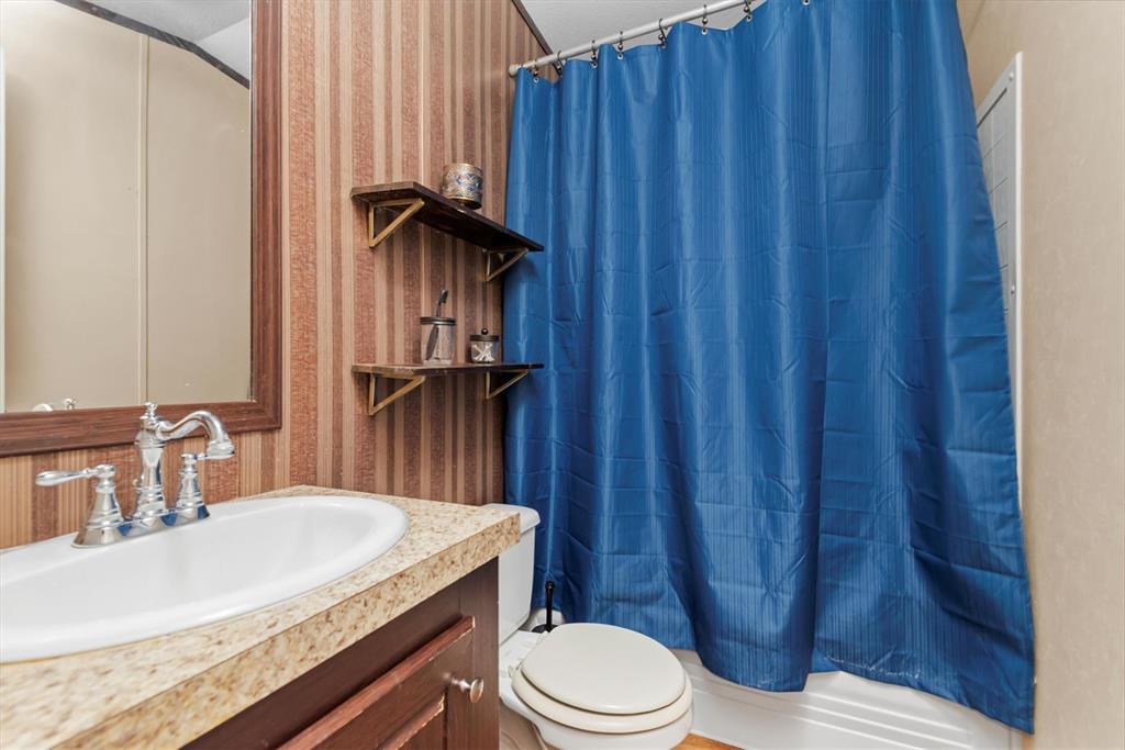 3759 Cr 126 Road Bedias, TX 77831 - Photo 32 of 38 a bathroom with a sink a toilet and shower