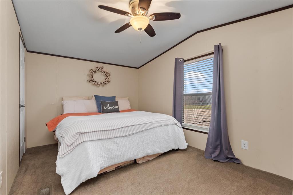 3759 Cr 126 Road Bedias, TX 77831 - Photo 33 of 38 a bedroom with a bed and a chandelier