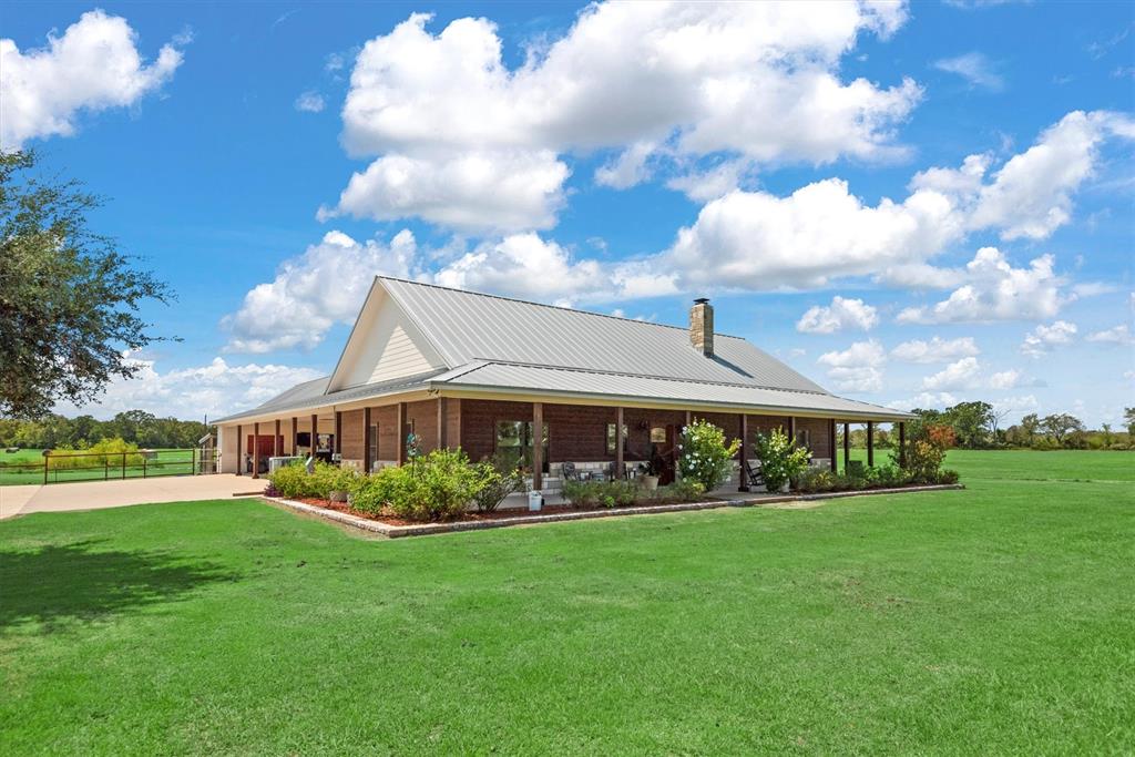 3759 Cr 126 Road Bedias, TX 77831 - Photo 38 of 38 a view of a white house with a big yard plants and large trees
