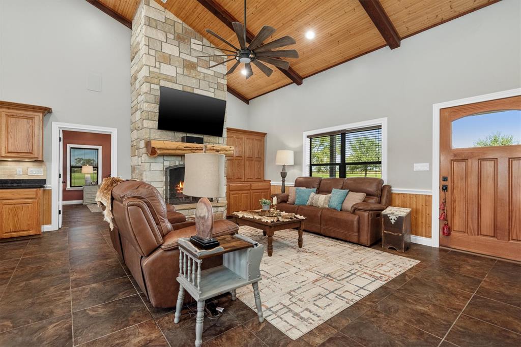 3759 Cr 126 Road Bedias, TX 77831 - Photo 8 of 38 a living room with furniture a flat screen tv and a fireplace