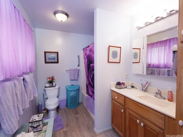 a bathroom with a sink mirror and toilet