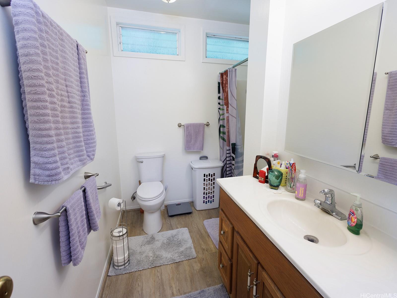 51-450 Kekio Road Kaaawa, HI 96730 - Photo 19 of 25 a bathroom with a sink vanity mirror and toilet