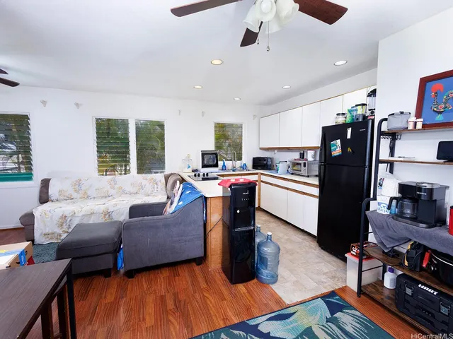 a living room with furniture and kitchen view