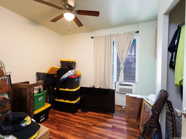 a living room with furniture a flat screen tv and a window