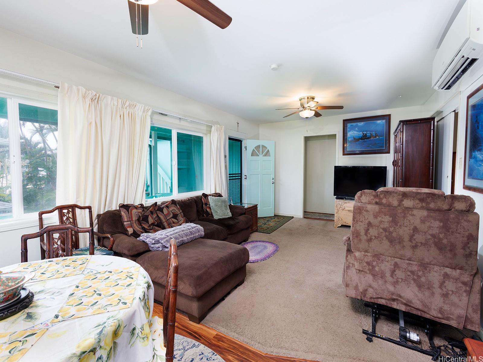 51-450 Kekio Road Kaaawa, HI 96730 - Photo 8 of 25 a living room with furniture a fireplace and a window