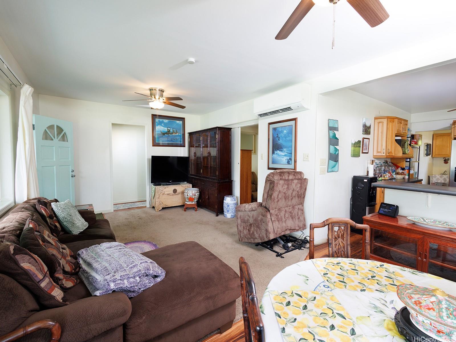 51-450 Kekio Road Kaaawa, HI 96730 - Photo 10 of 25 a living room with furniture fireplace and flat screen tv
