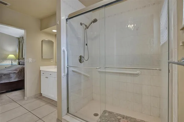 a en suite bathroom with a granite countertop sink and a mirror