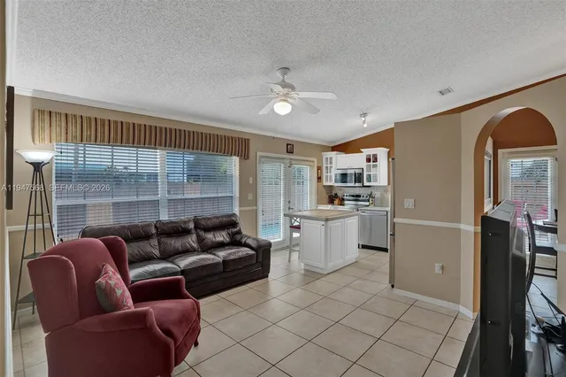 a kitchen with stainless steel appliances kitchen island granite countertop a refrigerator and a stove top oven