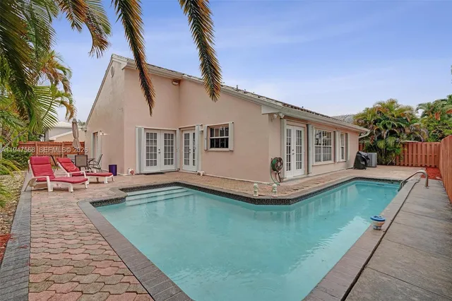 a view of a backyard with potted plants
