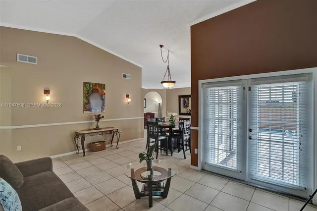 a dining room with furniture and window