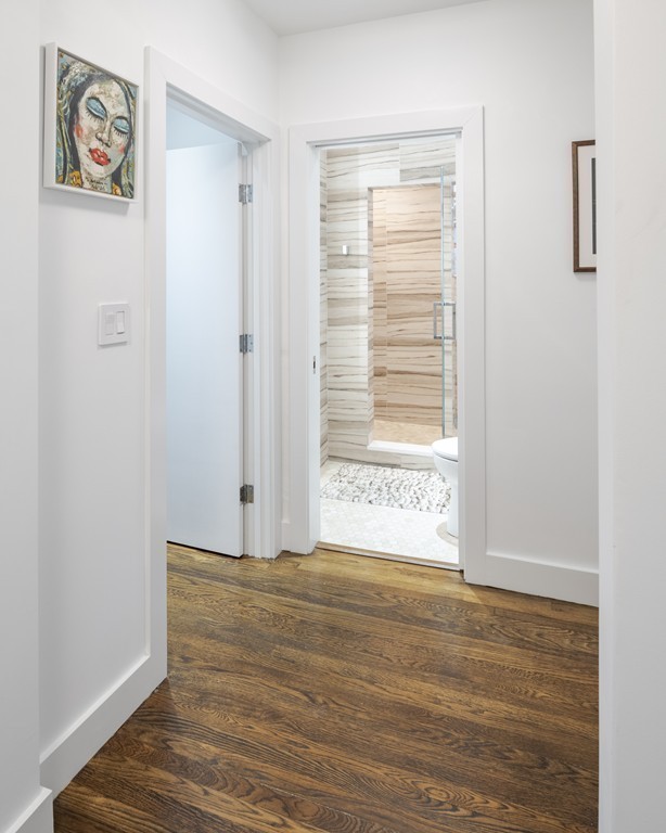 1490 Beacon Street, Unit 4 Brookline, MA 02446 - Photo 14 of 26 a view of an empty room with wooden floor and a window