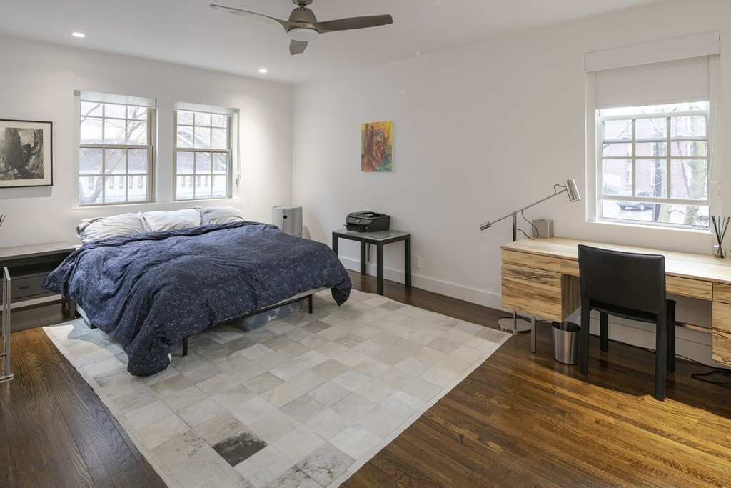 1490 Beacon Street, Unit 4 Brookline, MA 02446 - Photo 17 of 26 a bedroom with a bed a table and windows