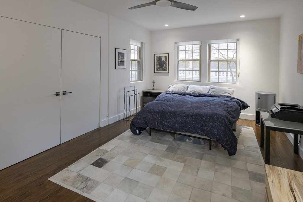 1490 Beacon Street, Unit 4 Brookline, MA 02446 - Photo 18 of 26 a spacious bedroom with a bed and wooden floor