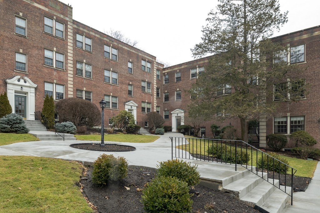 1490 Beacon Street, Unit 4 Brookline, MA 02446 - Photo 2 of 26 a view of a tall building with a yard