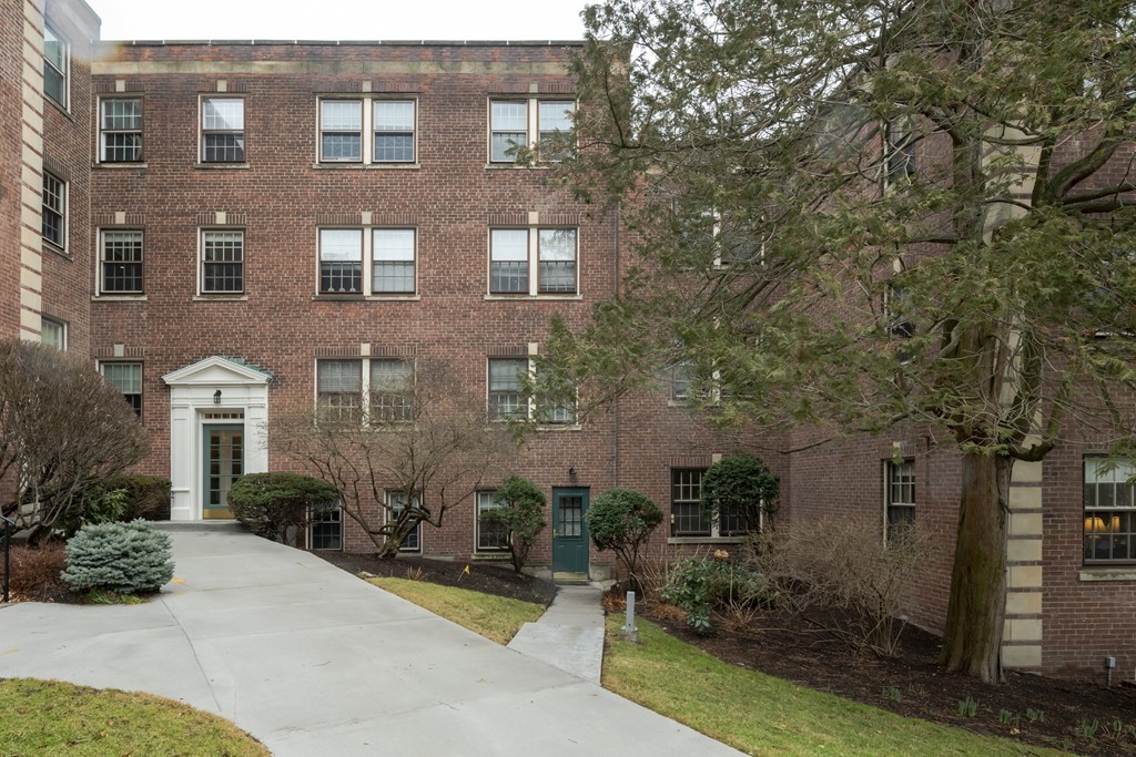 1490 Beacon Street, Unit 4 Brookline, MA 02446 - Photo 3 of 26 a view of a brick building next to a yard