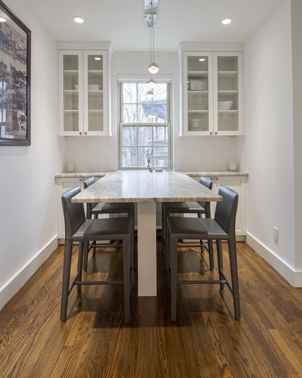 1490 Beacon Street, Unit 4 Brookline, MA 02446 - Photo 5 of 26 a view of a dining room with furniture wooden floor and chandelier