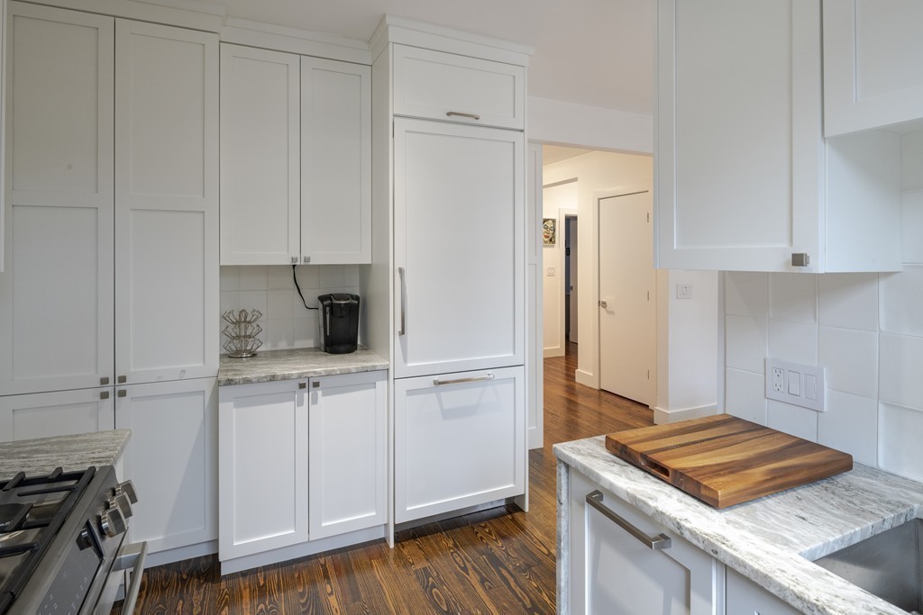 1490 Beacon Street, Unit 4 Brookline, MA 02446 - Photo 8 of 26 a kitchen with white cabinets and white appliances