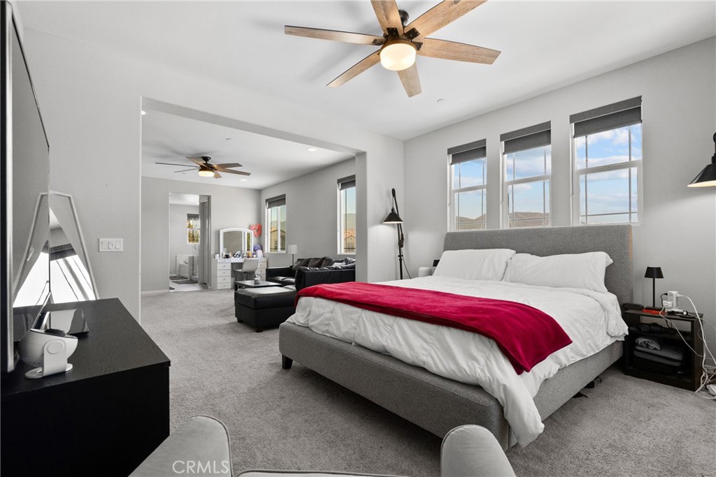 232 River Street Fillmore, CA 93015 - Photo 38 of 61 a spacious bedroom with a bed couch and a chandelier