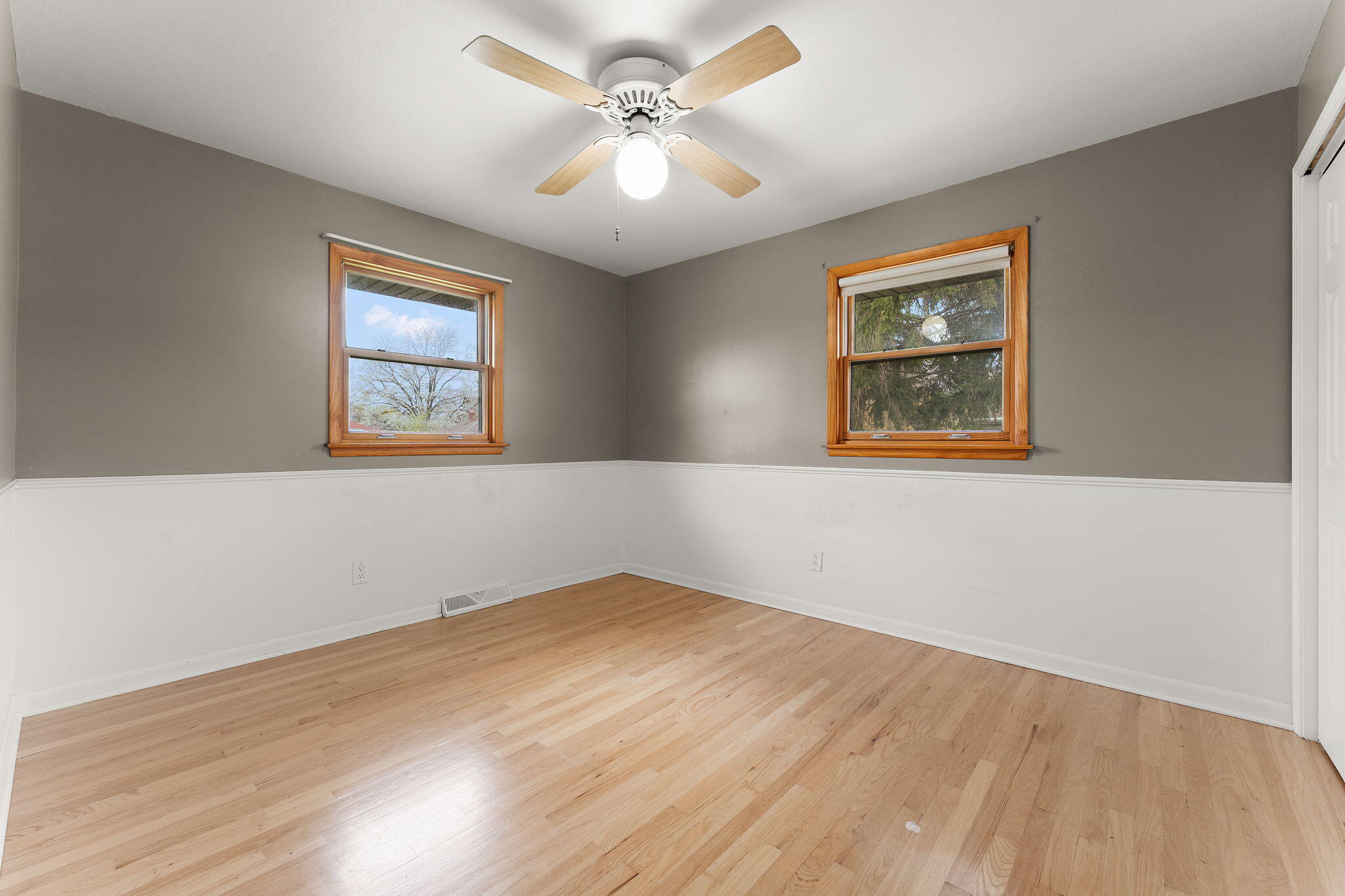 9217 Grace Street Highland, IN 46322 - Photo 13 of 29 a view of a big room with wooden floor and chandelier fan