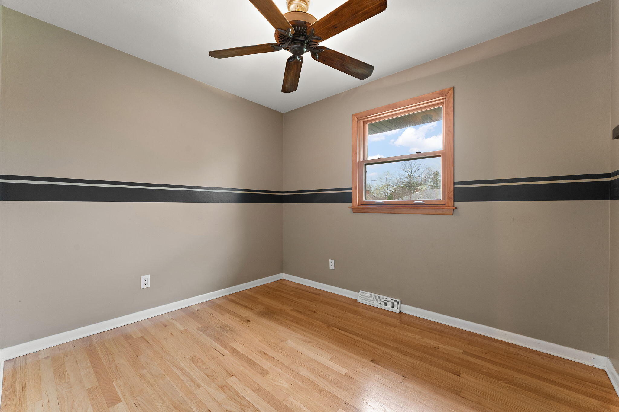 9217 Grace Street Highland, IN 46322 - Photo 14 of 29 a view of a big room with wooden floor and windows
