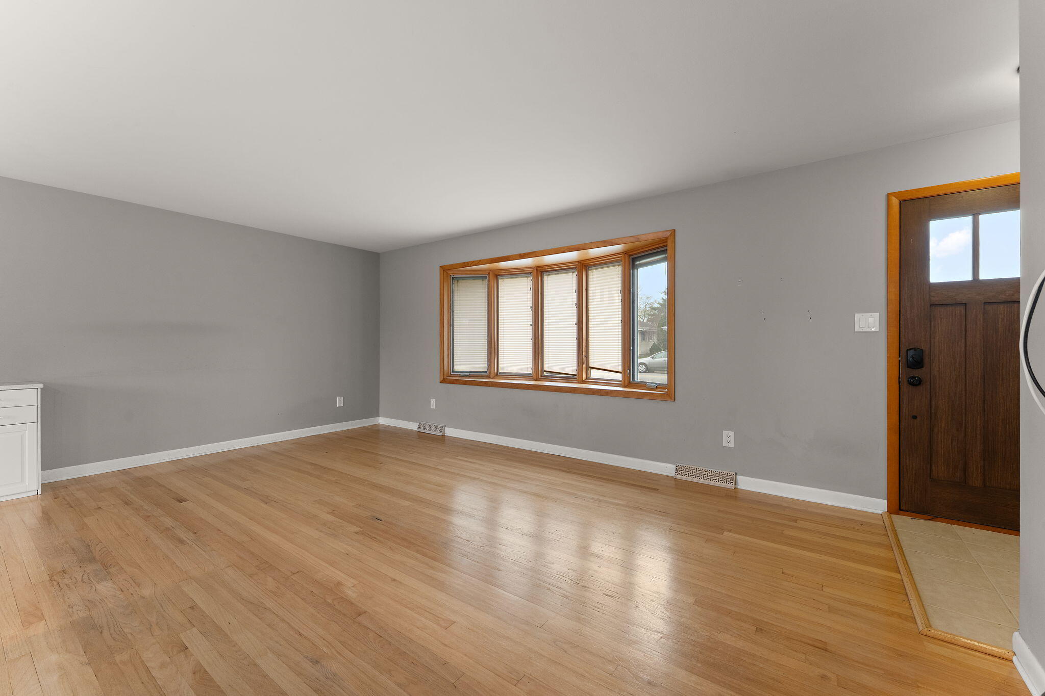 9217 Grace Street Highland, IN 46322 - Photo 4 of 29 a view of an empty room with wooden floor and a window