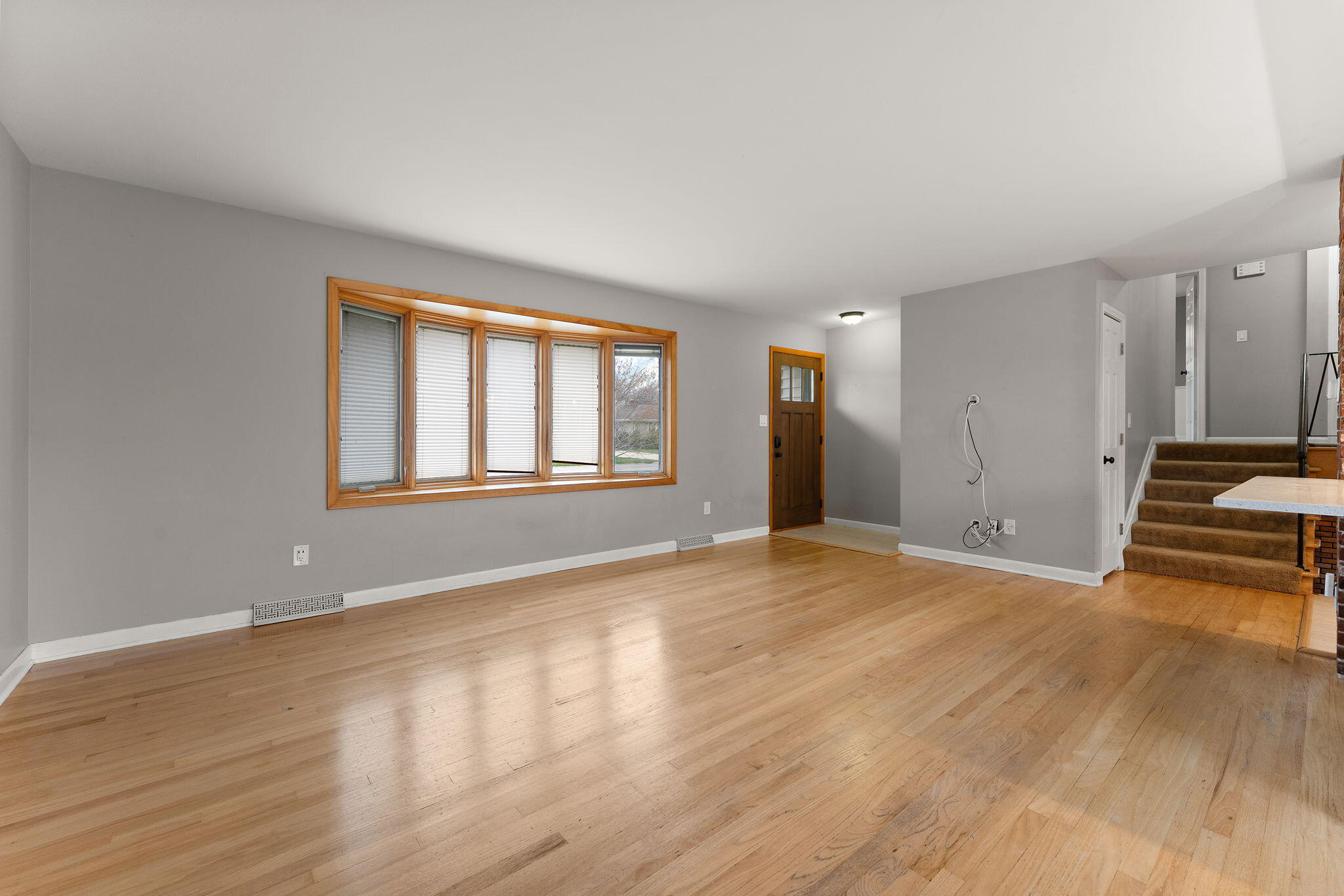 9217 Grace Street Highland, IN 46322 - Photo 6 of 29 a view of empty room with wooden floor and fan