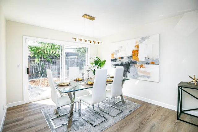a dining room with furniture and a floor to ceiling window