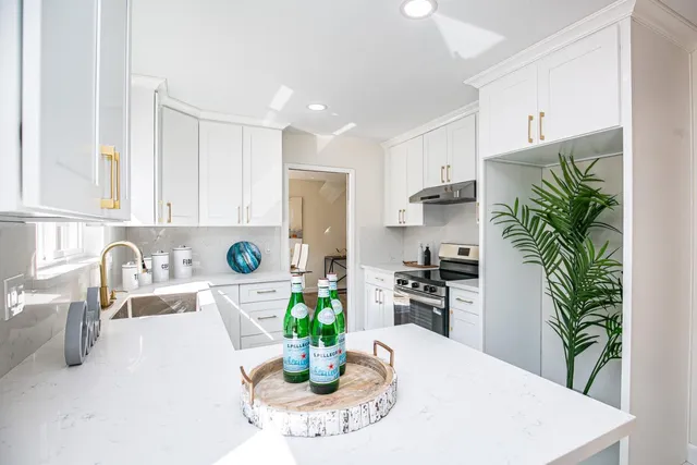 a kitchen with a white table and chairs