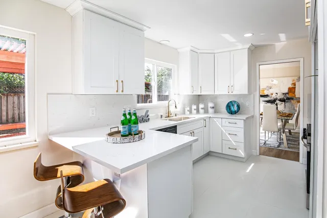 a kitchen with a sink cabinets and window