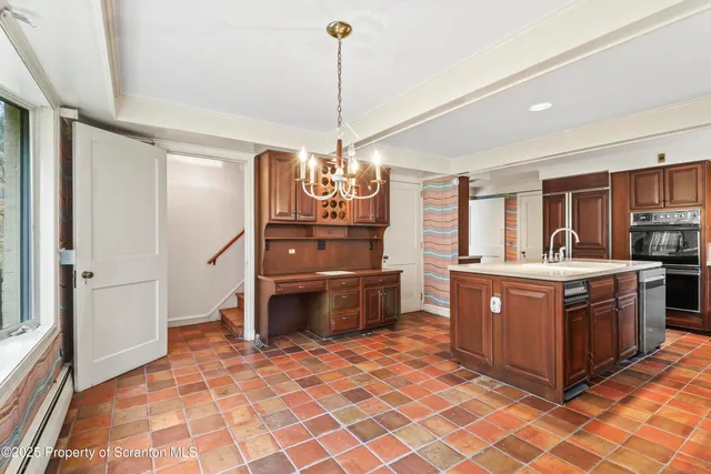 a kitchen with a stove a sink and a refrigerator