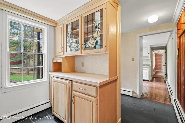 a view of empty room with wooden floor and fireplace