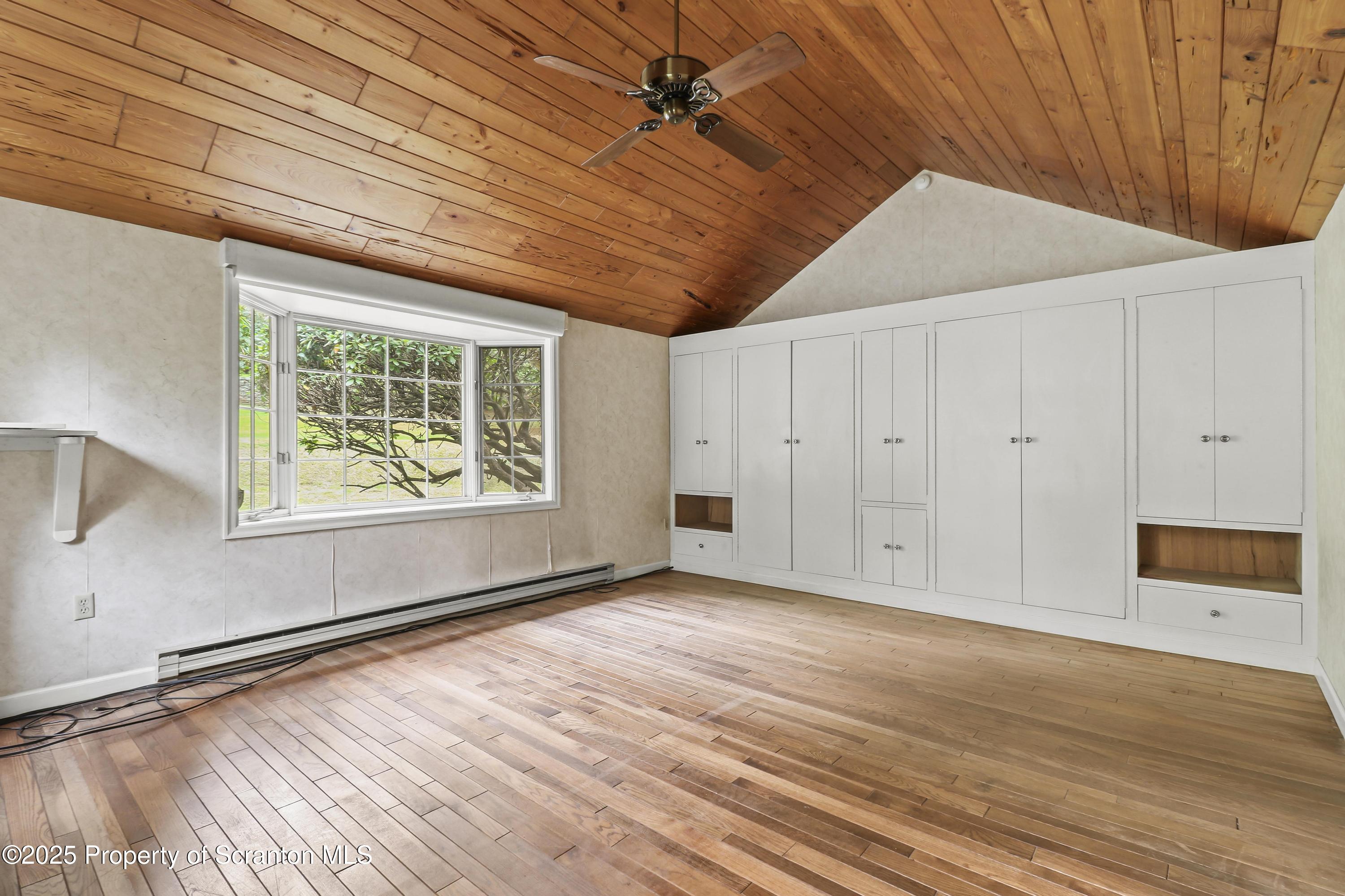 28 Church Hill Road Dalton, PA 18414 - Photo 17 of 63 a view of an empty room with a window and wooden floor