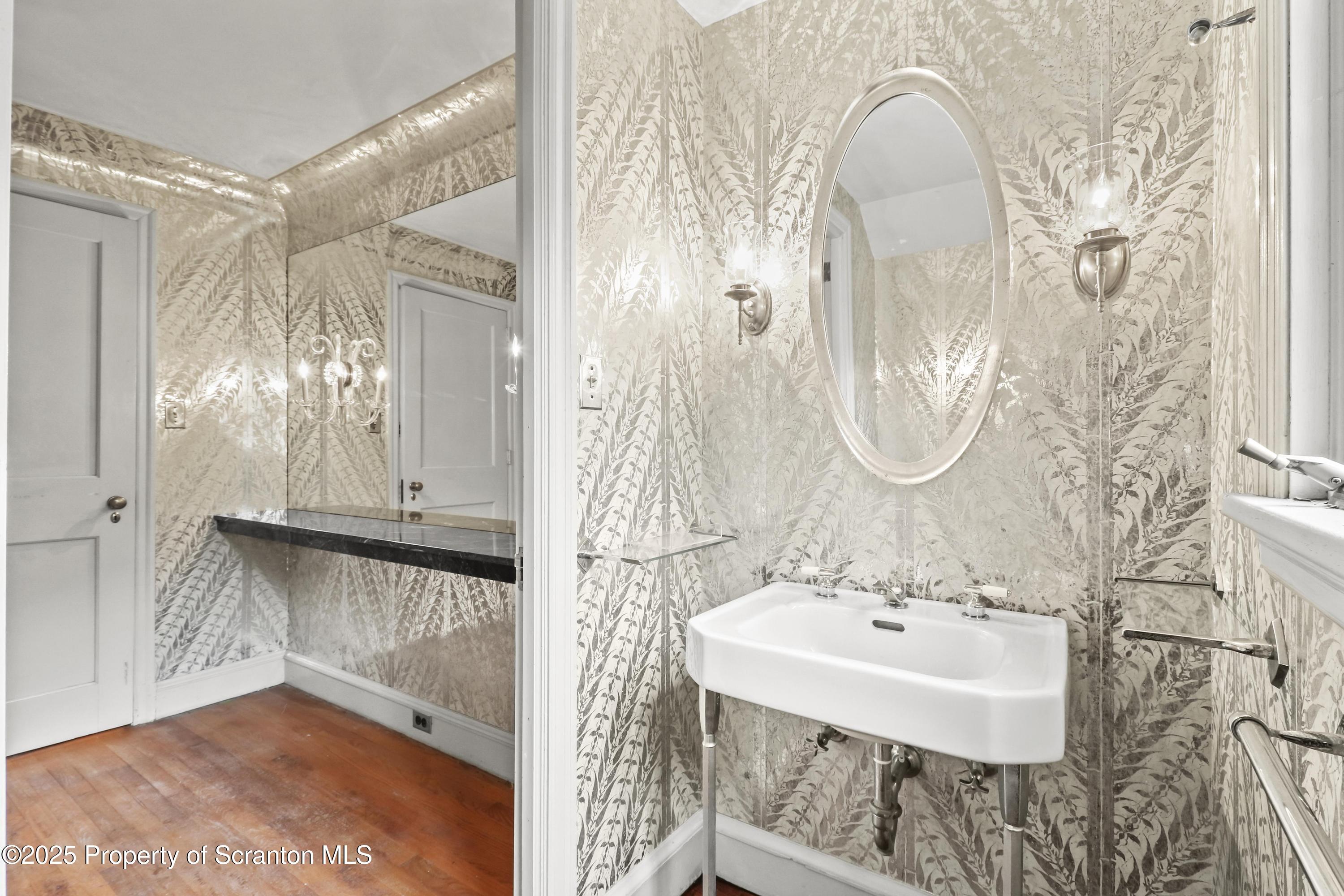 28 Church Hill Road Dalton, PA 18414 - Photo 22 of 63 a bathroom with a sink a mirror and a shower