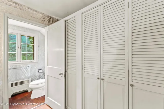 a bathroom with a sink a toilet a mirror and shower