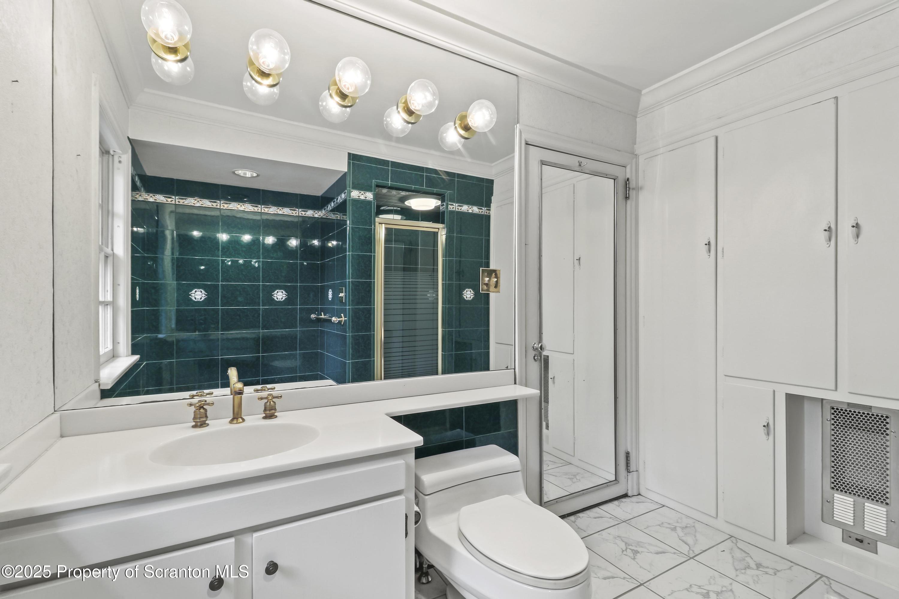 28 Church Hill Road Dalton, PA 18414 - Photo 27 of 63 a bathroom with a sink a toilet a mirror and shower