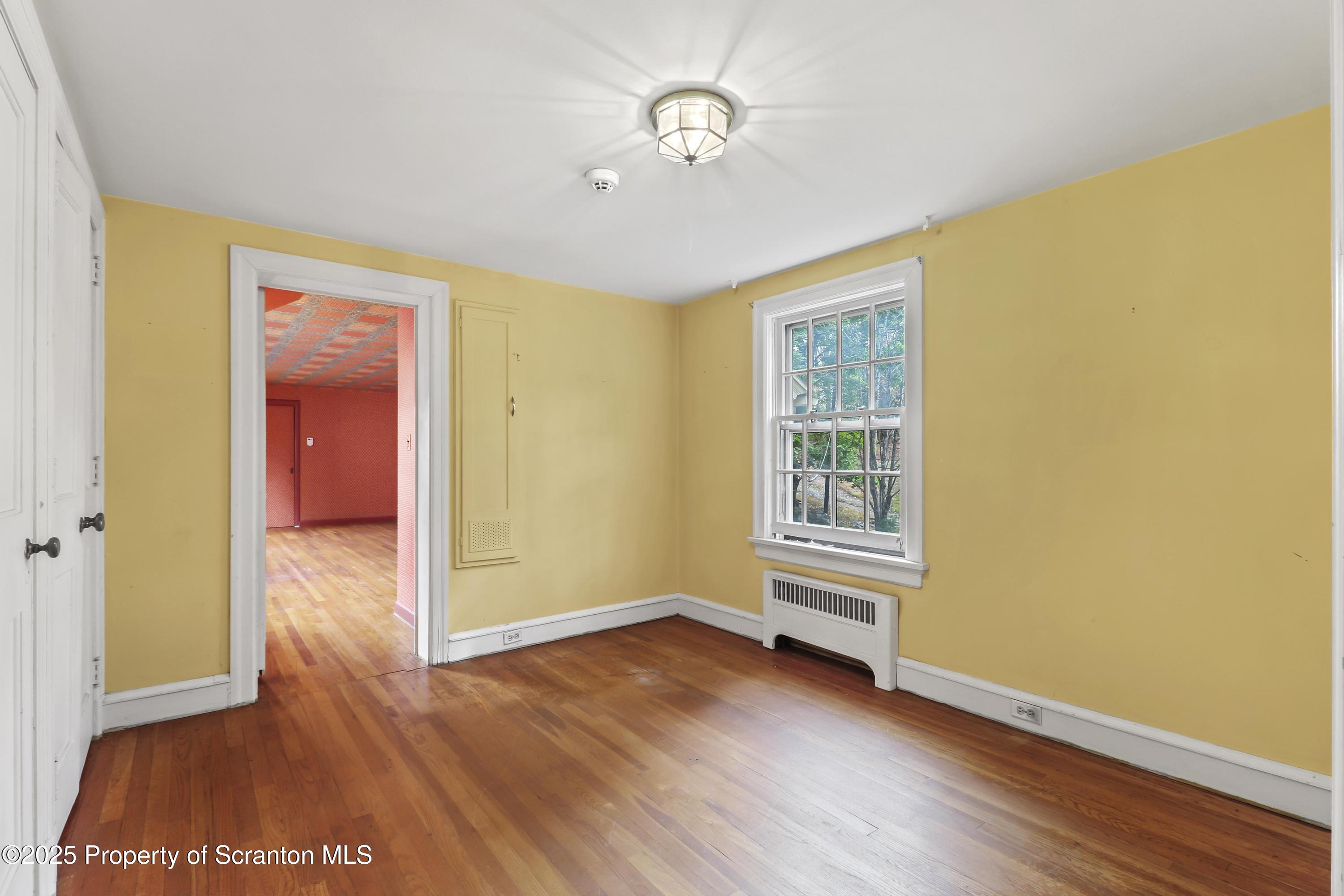 28 Church Hill Road Dalton, PA 18414 - Photo 39 of 63 a view of an empty room with wooden floor and a window