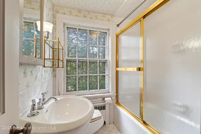 a view of a house with a yard and large tree