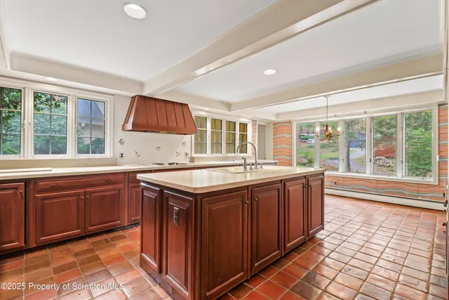 a kitchen with stainless steel appliances granite countertop a sink and a refrigerator