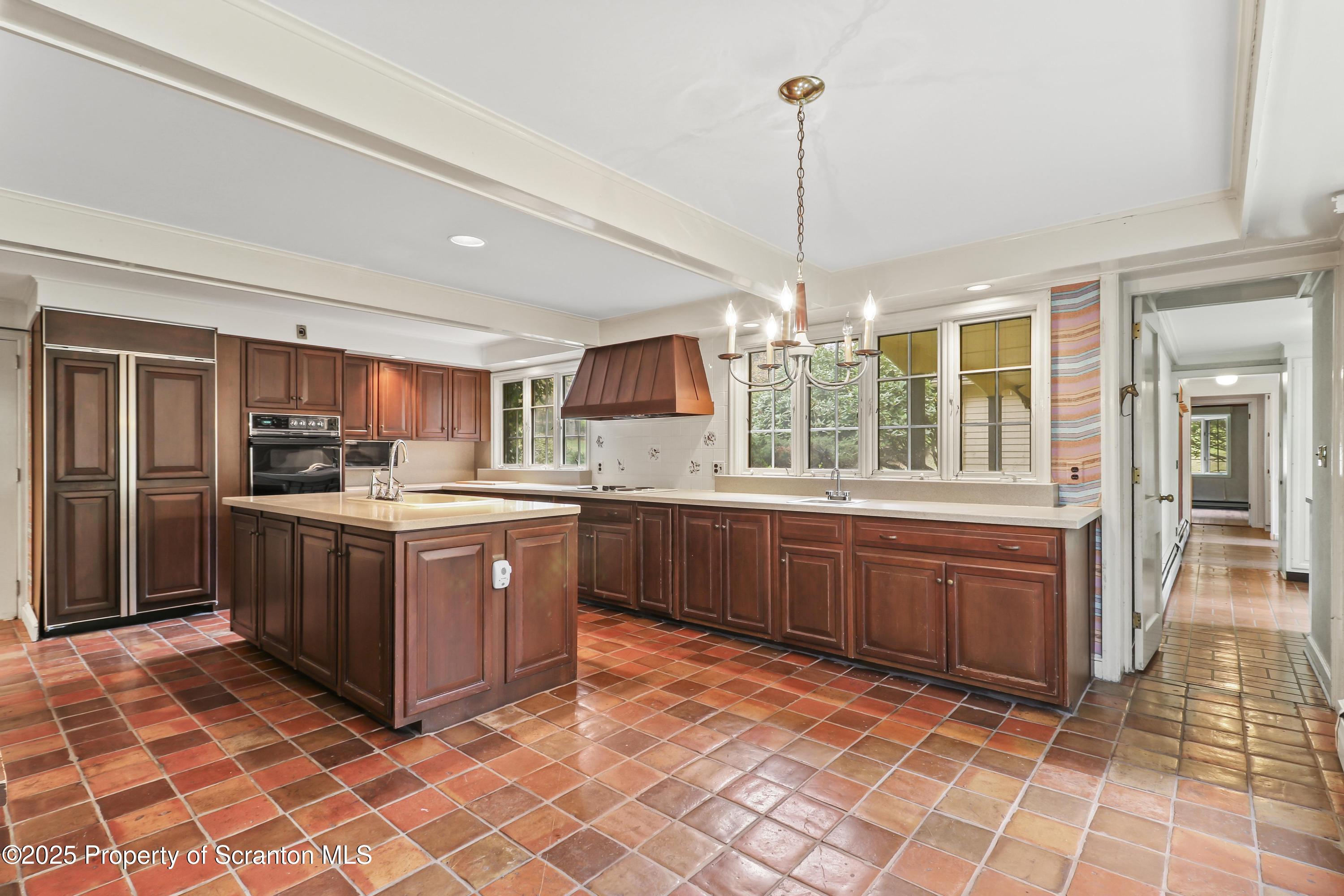 28 Church Hill Road Dalton, PA 18414 - Photo 10 of 63 a kitchen with stainless steel appliances granite countertop a stove a sink dishwasher a refrigerator a oven with wooden cabinets and dining table