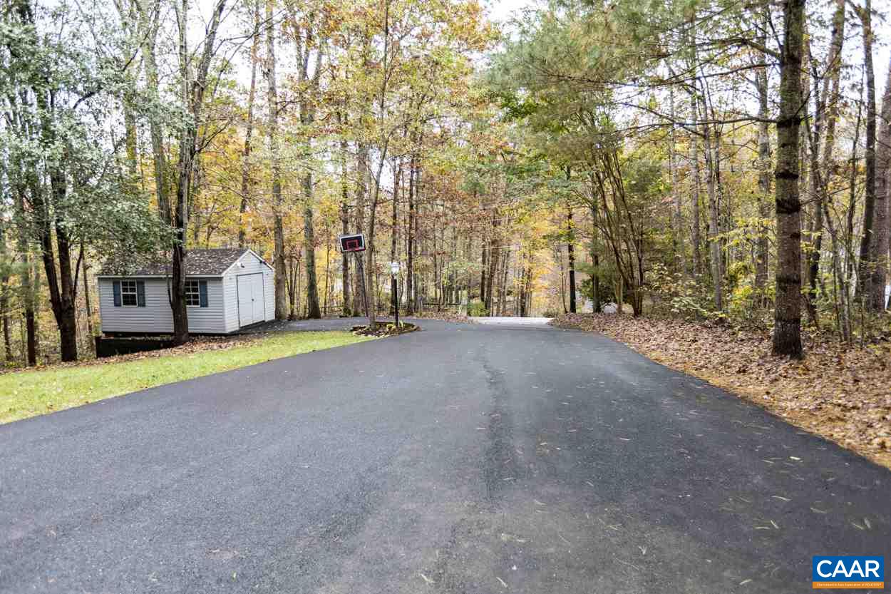 466 Carnation Road Ruckersville, VA 22968 - Photo 32 of 36 a view of a house with a large tree and wooden fence