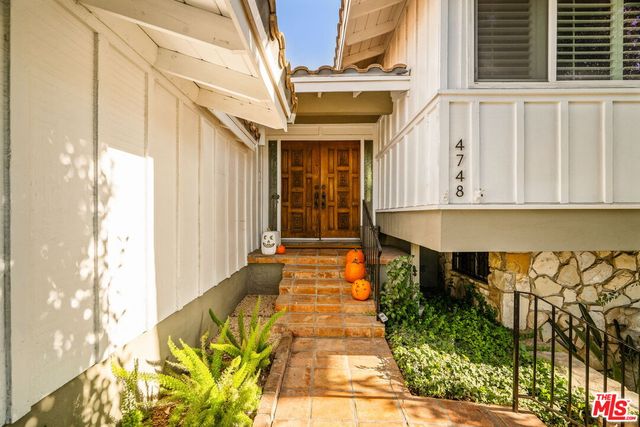a view of a brick house with large windows