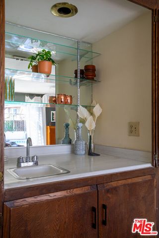 a bathroom with a double vanity sink and mirror with bathtub