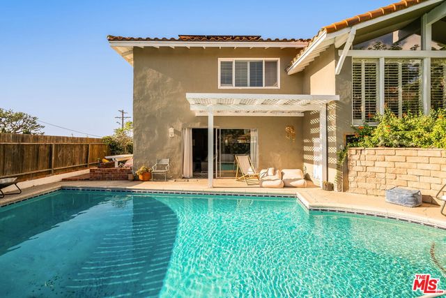 a view of a house with a yard and sitting area